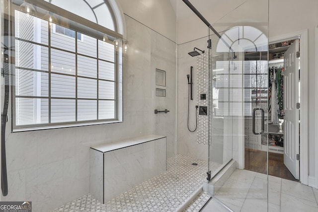 bathroom featuring a shower with shower door