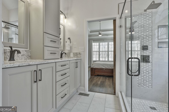 bathroom with a shower with door, vanity, decorative backsplash, ceiling fan, and beam ceiling