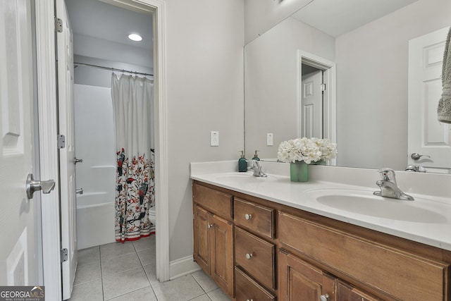 bathroom featuring toilet, vanity, and tile patterned flooring