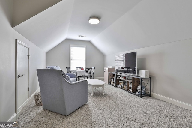 living room with vaulted ceiling and carpet flooring