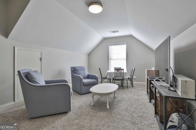 interior space with carpet and vaulted ceiling