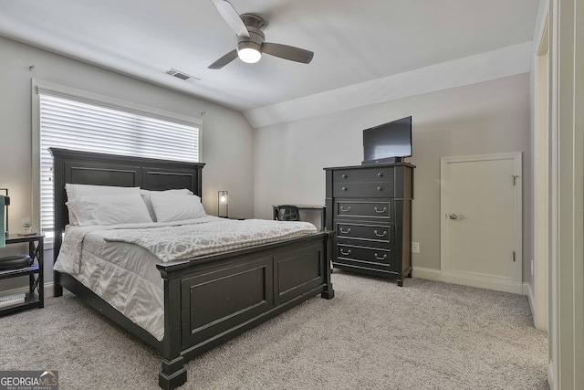 carpeted bedroom with ceiling fan and vaulted ceiling