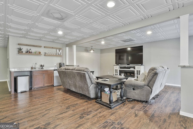 living room featuring indoor wet bar and dark hardwood / wood-style floors