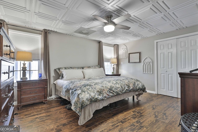 bedroom with ceiling fan, dark hardwood / wood-style flooring, and a closet