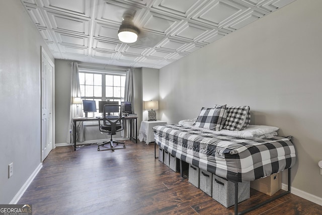 bedroom with dark hardwood / wood-style floors