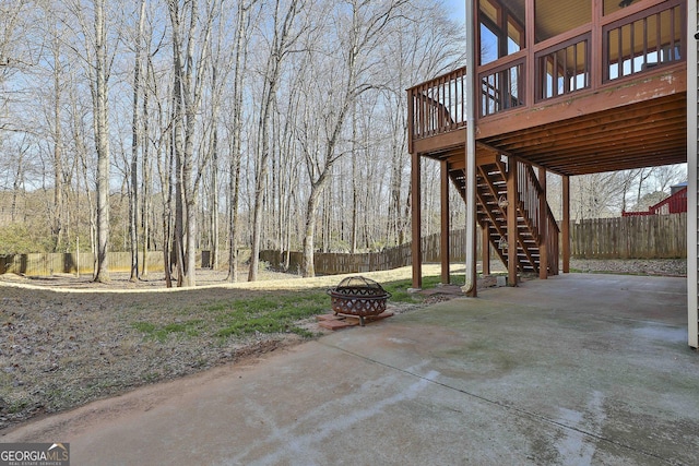 view of patio with an outdoor fire pit and a deck