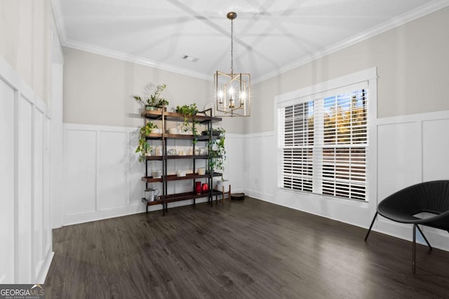 dining space with crown molding, dark hardwood / wood-style flooring, and a chandelier