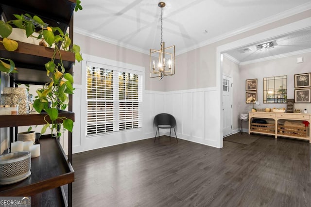 dining area featuring ornamental molding, dark wood-type flooring, and a chandelier