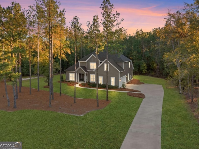 view of front of property with a yard and a garage