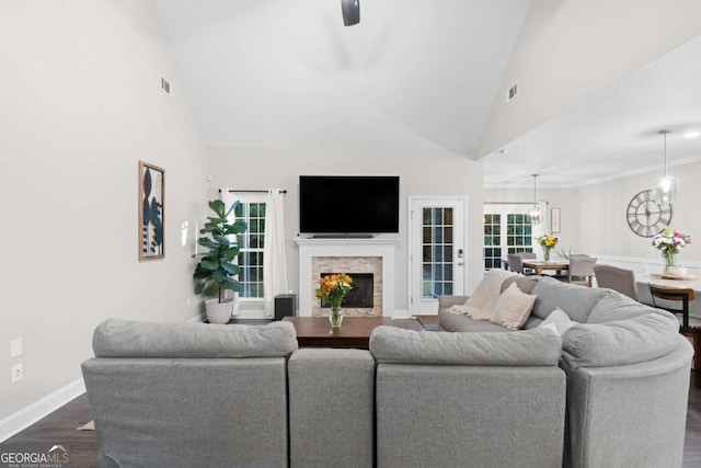 living room with dark hardwood / wood-style floors, high vaulted ceiling, and ceiling fan