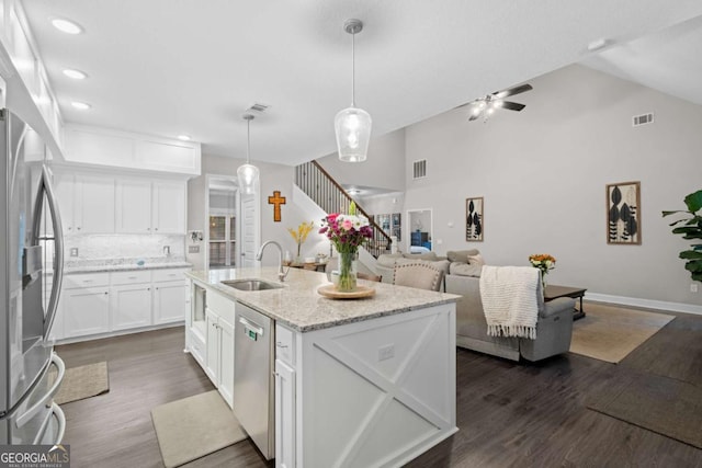 kitchen featuring sink, appliances with stainless steel finishes, tasteful backsplash, decorative light fixtures, and white cabinetry