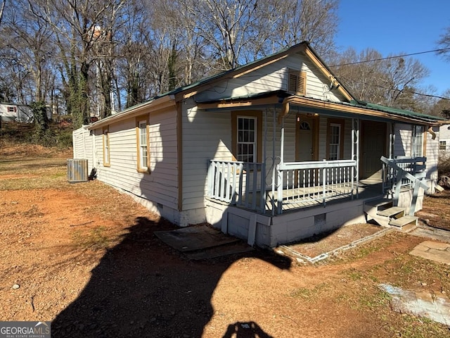 bungalow-style house featuring covered porch and central air condition unit