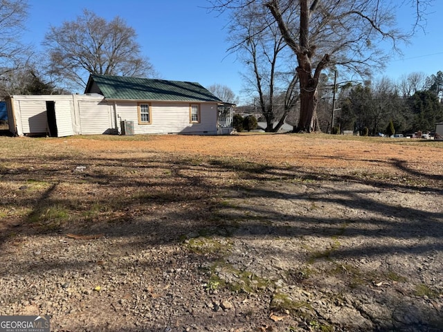 view of yard featuring central AC and a storage shed