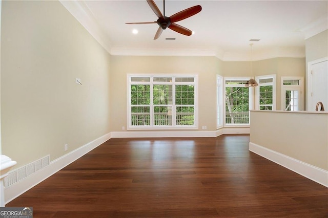 spare room featuring crown molding, ceiling fan, and dark hardwood / wood-style floors