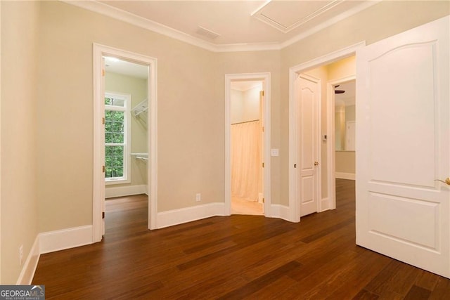 unfurnished room with ornamental molding and dark wood-type flooring