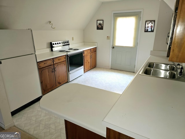 kitchen with kitchen peninsula, white appliances, vaulted ceiling, and sink