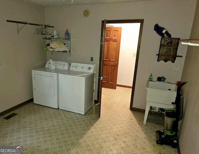 laundry area featuring washing machine and dryer and sink