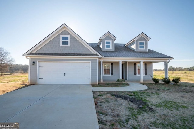 view of front of property with a porch and a garage