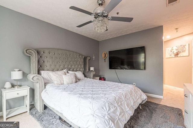 bedroom featuring light colored carpet and ceiling fan