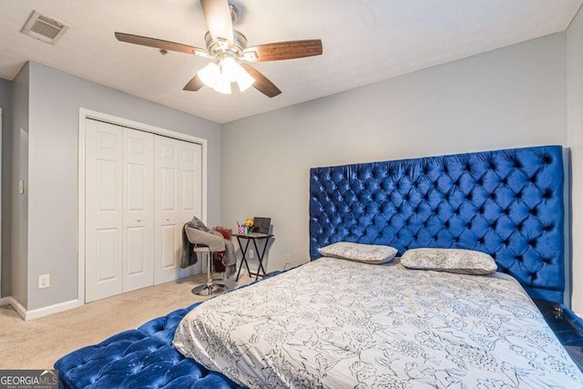 carpeted bedroom with ceiling fan and a closet