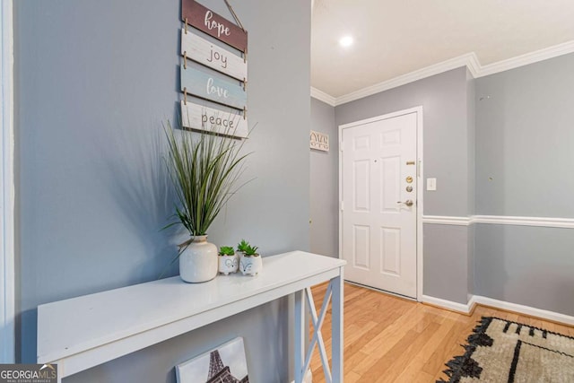 entryway with crown molding and hardwood / wood-style flooring