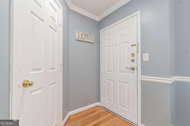 doorway to outside featuring light hardwood / wood-style flooring and ornamental molding