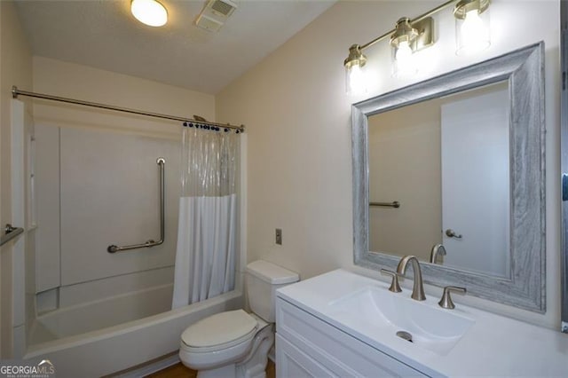 full bathroom featuring vanity, shower / bath combination with curtain, and toilet