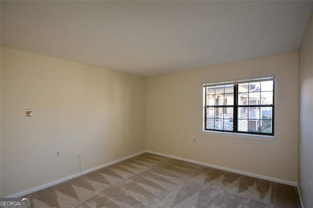 unfurnished room with light carpet