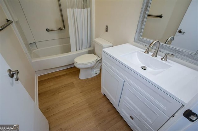 full bathroom featuring hardwood / wood-style floors, vanity, shower / tub combo, and toilet