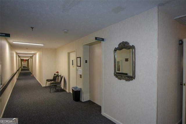 corridor with dark colored carpet