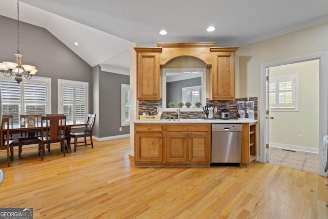 kitchen featuring hanging light fixtures, light hardwood / wood-style flooring, stainless steel dishwasher, backsplash, and lofted ceiling