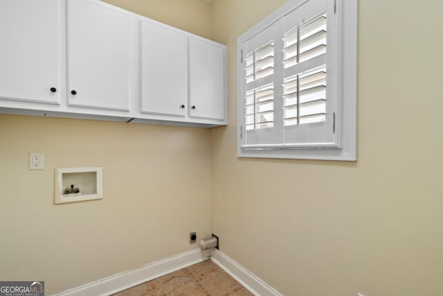 laundry area with electric dryer hookup, a healthy amount of sunlight, cabinets, and washer hookup