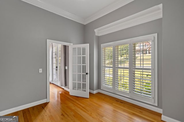 unfurnished room featuring hardwood / wood-style flooring and ornamental molding