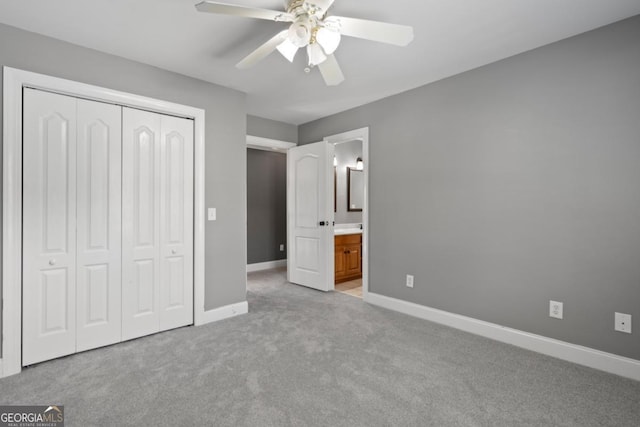 unfurnished bedroom with ceiling fan, a closet, ensuite bathroom, and light carpet