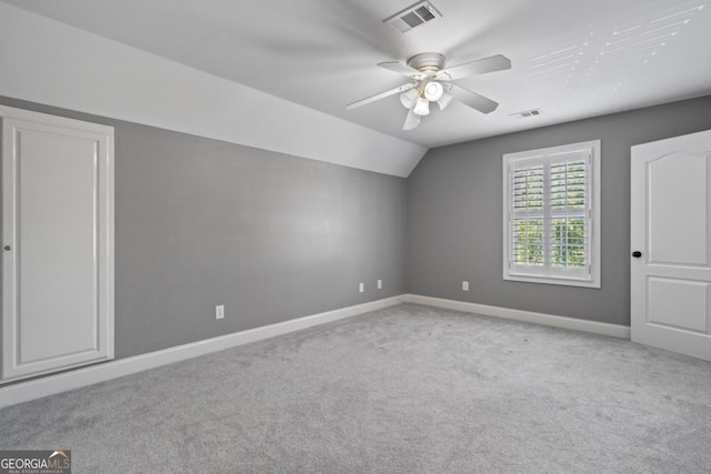 additional living space featuring light colored carpet, vaulted ceiling, and ceiling fan