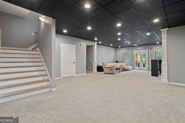 living room with a paneled ceiling and light carpet