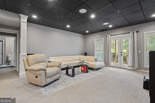 living room featuring light carpet, french doors, and a drop ceiling