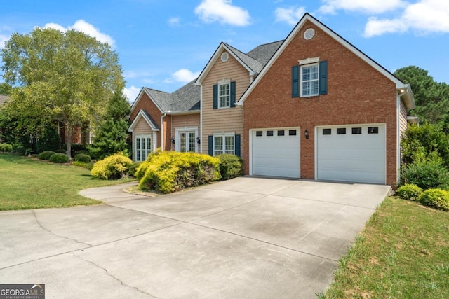 view of front facade with a front yard and a garage