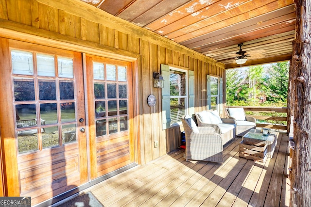 wooden terrace with ceiling fan and french doors