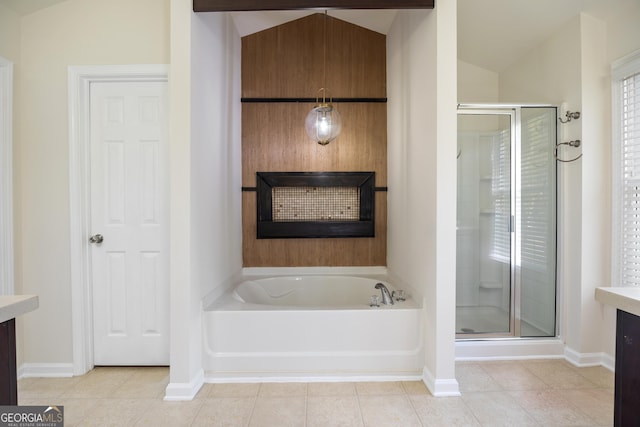 bathroom with tile patterned flooring, vanity, vaulted ceiling, and shower with separate bathtub