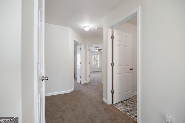 hall featuring light colored carpet