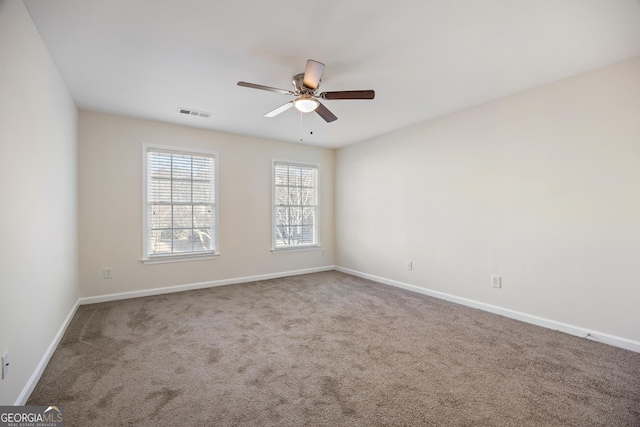 carpeted spare room featuring ceiling fan