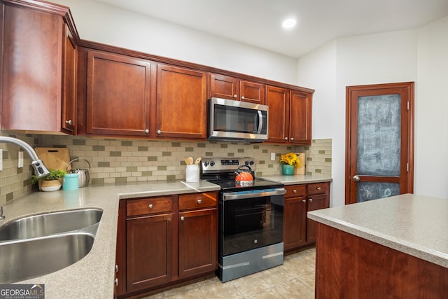 kitchen with decorative backsplash, sink, and appliances with stainless steel finishes