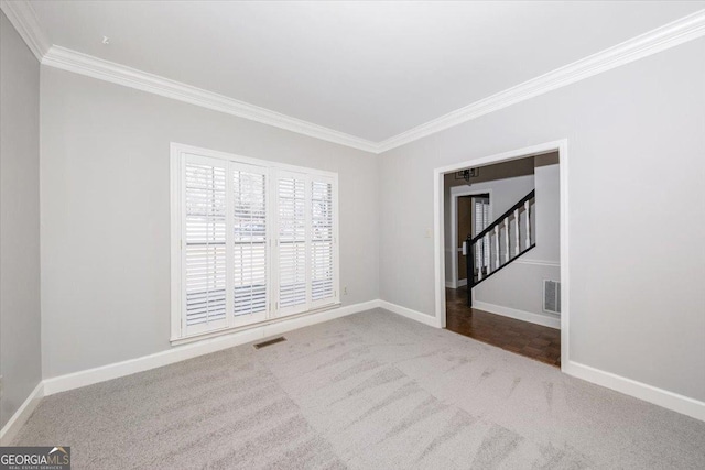 spare room featuring carpet floors and crown molding