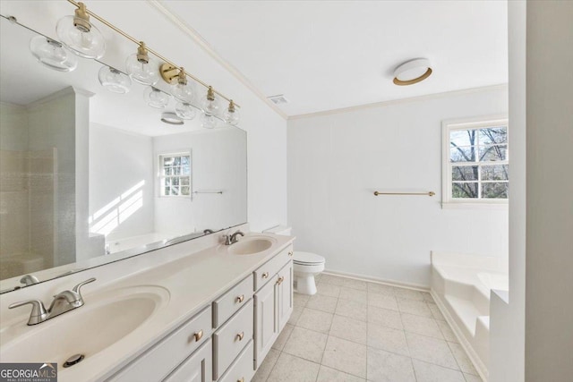 bathroom featuring vanity, crown molding, tile patterned flooring, toilet, and a bathing tub