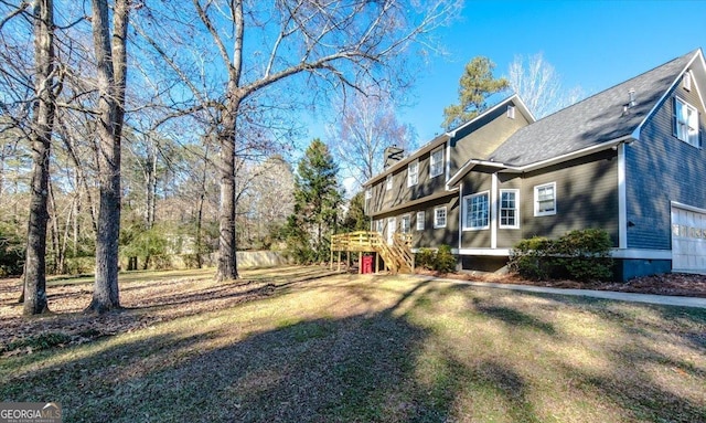 view of yard featuring a garage and a deck