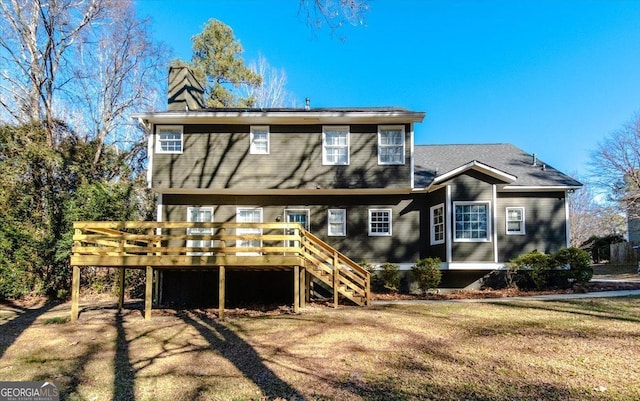 back of house with a yard and a deck