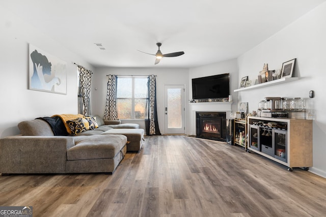 living room with hardwood / wood-style flooring and ceiling fan