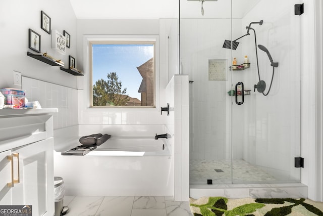 bathroom featuring shower with separate bathtub