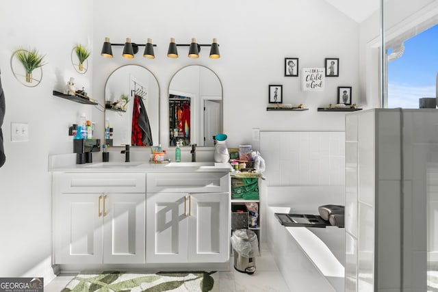 bathroom featuring vanity and lofted ceiling